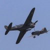 An American P-40 aircraft pursues a Japanese Zero